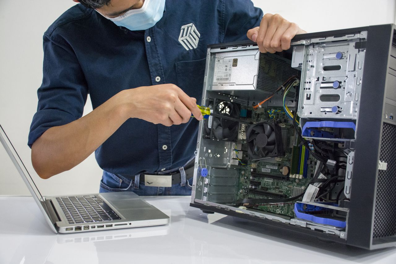 Mastering the First Impression: Your intriguing post title goes here A technician repairs a desktop computer in an indoor setting, illustrating tech maintenance.